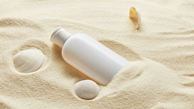 sunscreen-bottle-in-sand